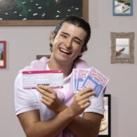 front-view-man-holding-lottery-tickets-min